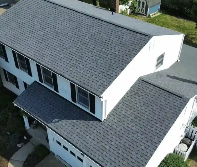 Residential building with newly installed shingles on roof